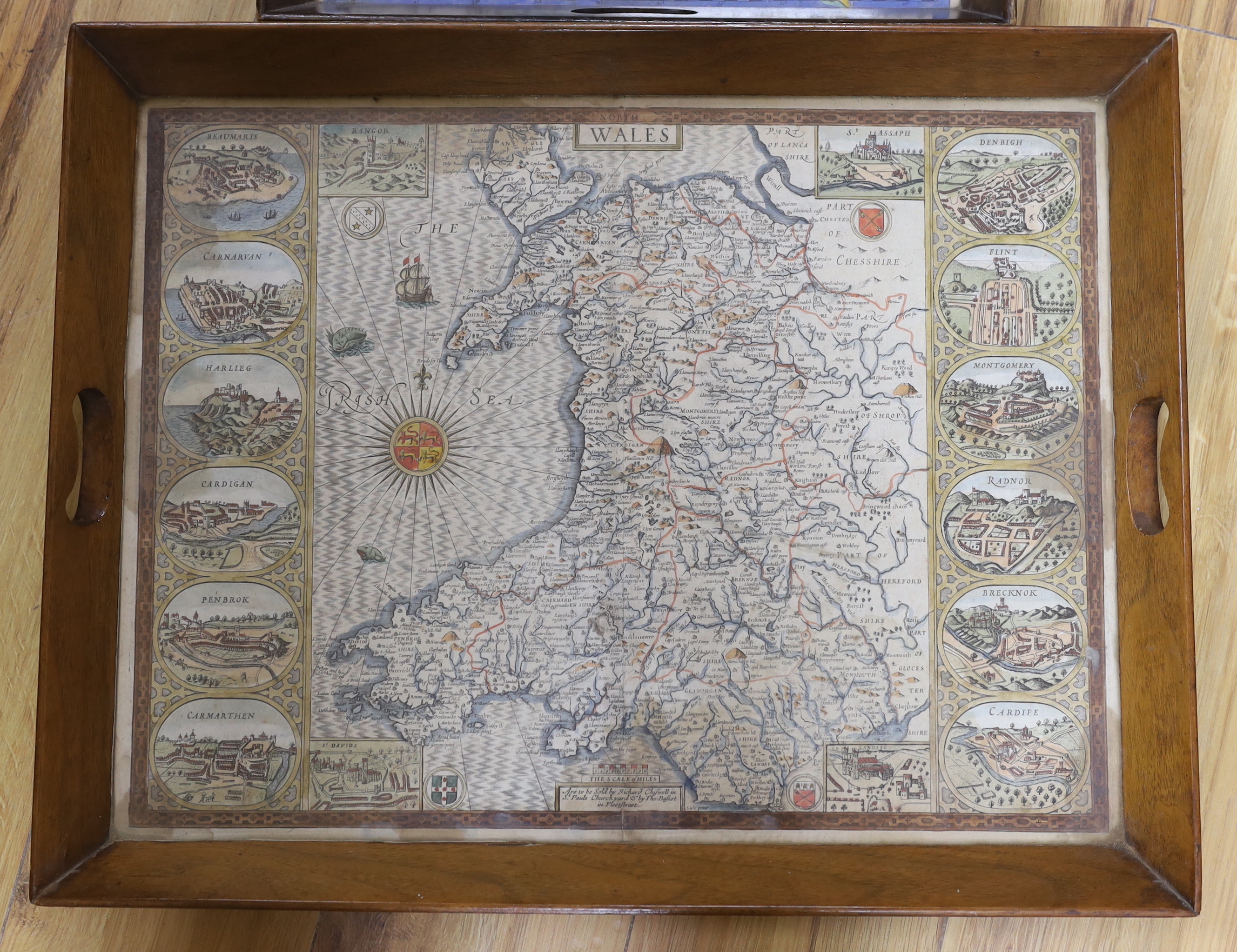 An 18th century hand coloured map of Wales, framed as a twin handled drink’s tray, together with another after Robert Morden, Buckinghamshire, largest 58cm wide (2)